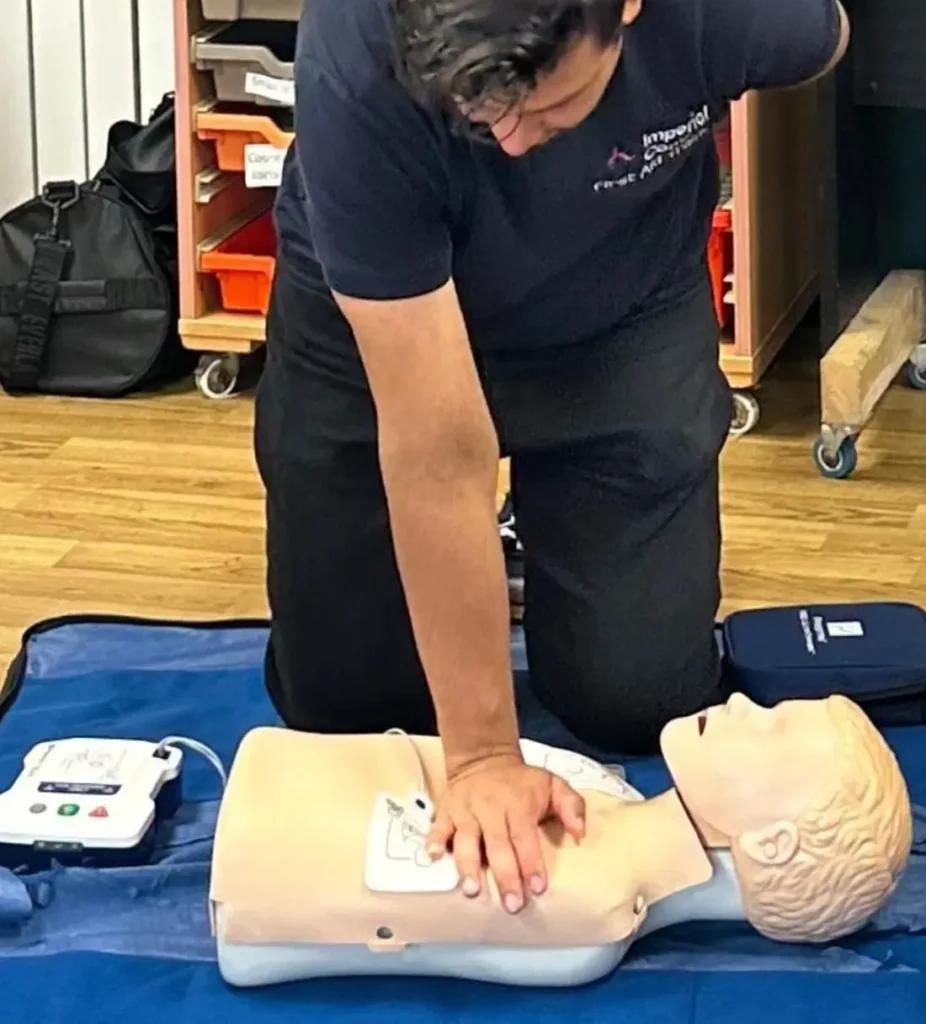 Trainer demonstrating infant CPR during a paediatric first aid course
